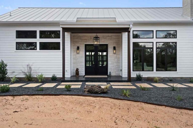 Exterior view of a white house featuring a black front door at Cherokee Creek in Texas