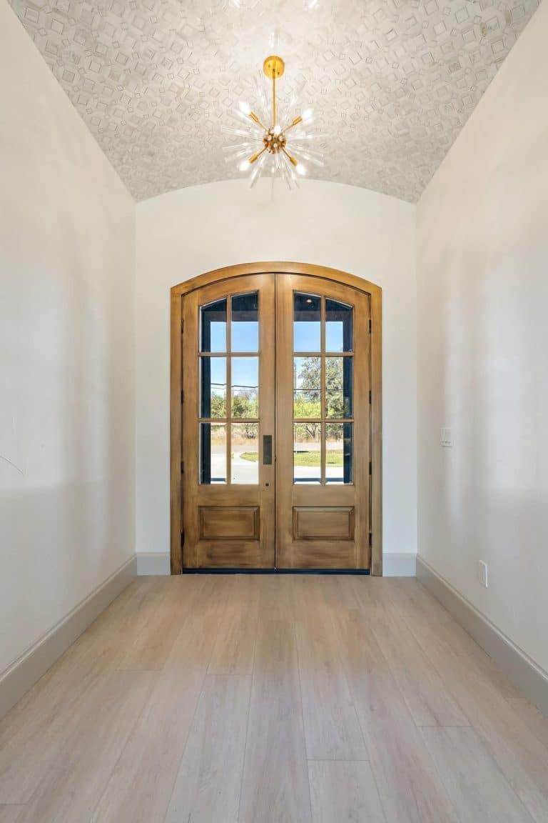 Elegant room with chandelier and wood doors featured in Granite Shoals Lodge Gallery near Austin TX