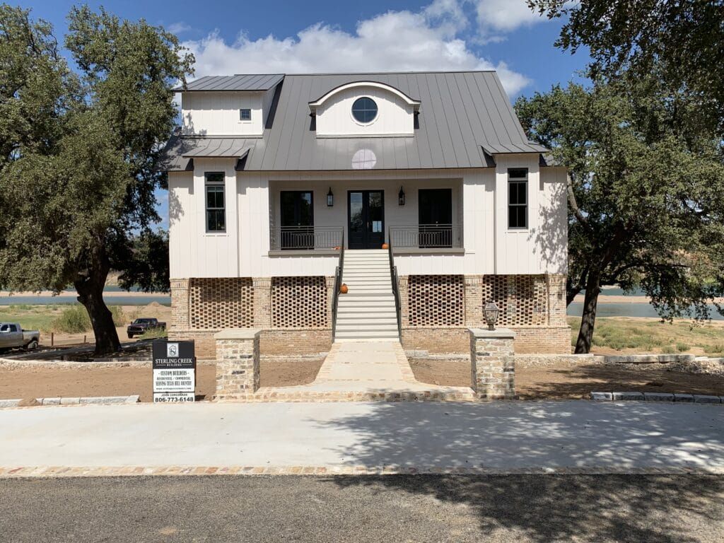 The White Manor features a spacious front porch and a driveway, located between Austin and Dallas, TX
